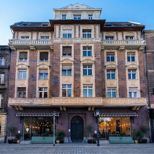 The historic brick building at Lánchíd utca 41 in Budapest, photographed in bright natural daylight.